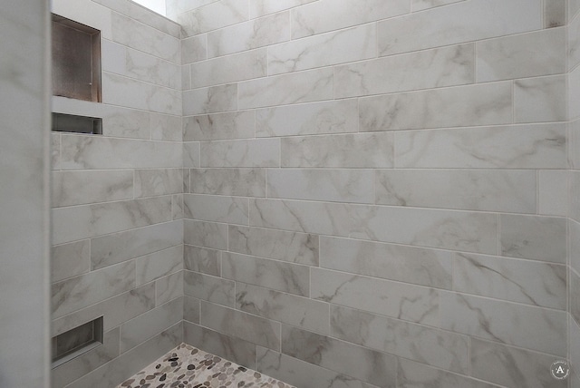 full bath with tiled shower