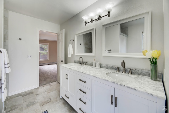 bathroom with baseboards, a sink, baseboard heating, and double vanity