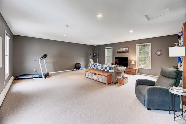 carpeted living area featuring attic access, recessed lighting, a baseboard heating unit, and baseboards