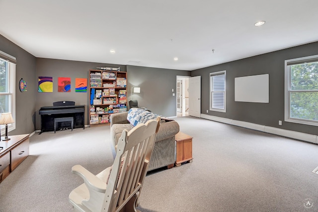 living area featuring light carpet, baseboards, and recessed lighting