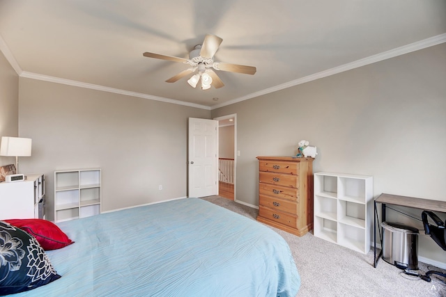 carpeted bedroom with ceiling fan, ornamental molding, and baseboards