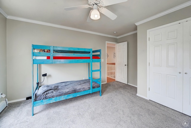 bedroom featuring baseboards, carpet floors, ceiling fan, and crown molding