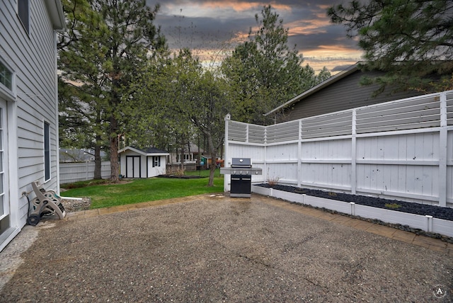 exterior space with an outbuilding, fence, and a storage shed