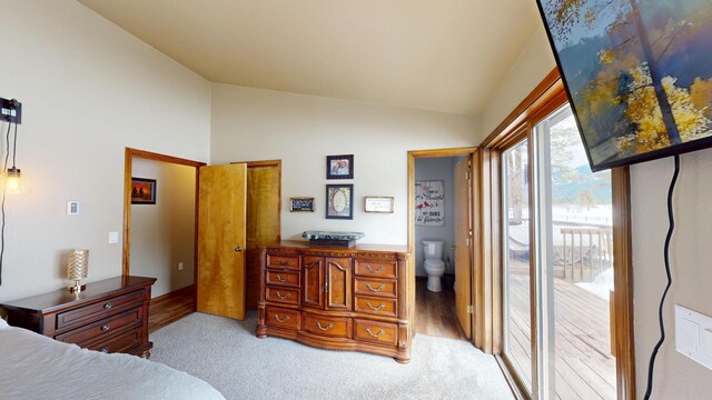 bedroom with access to outside, light colored carpet, and vaulted ceiling