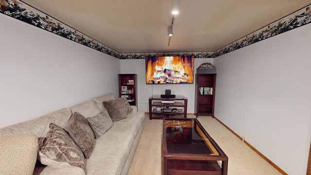 living area featuring track lighting, carpet flooring, and baseboards