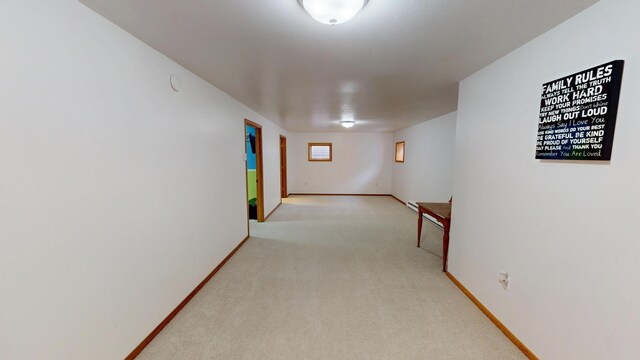 corridor featuring carpet and baseboards