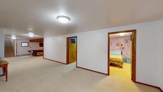 below grade area featuring baseboards, stairway, billiards, and light colored carpet