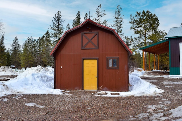 snow covered structure with an outdoor structure