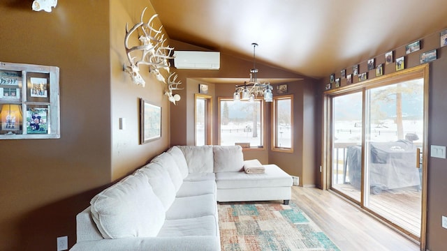 living area with lofted ceiling, light wood finished floors, a wall unit AC, and a wealth of natural light