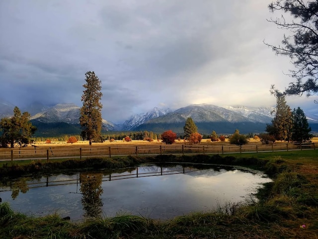 water view with fence and a mountain view