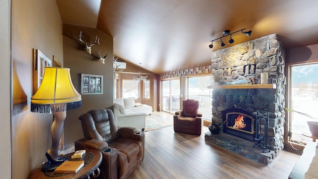 living area with lofted ceiling, a fireplace, and wood finished floors