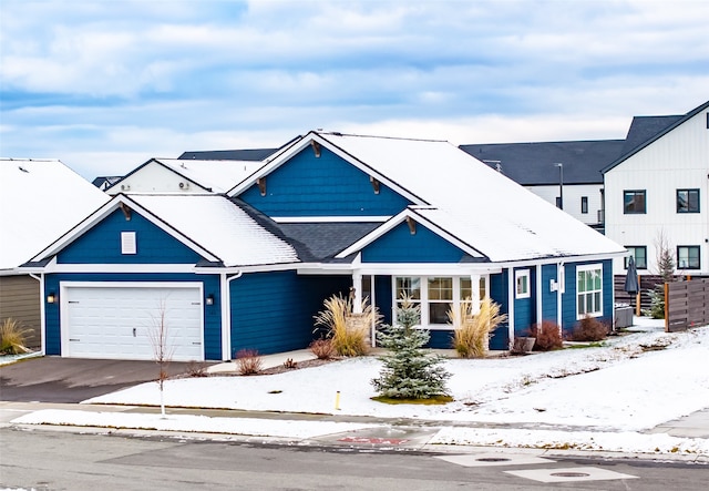 view of front facade featuring concrete driveway and an attached garage