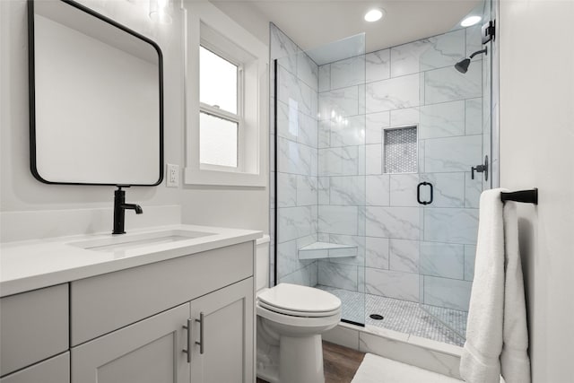 full bathroom with recessed lighting, toilet, a stall shower, vanity, and wood finished floors