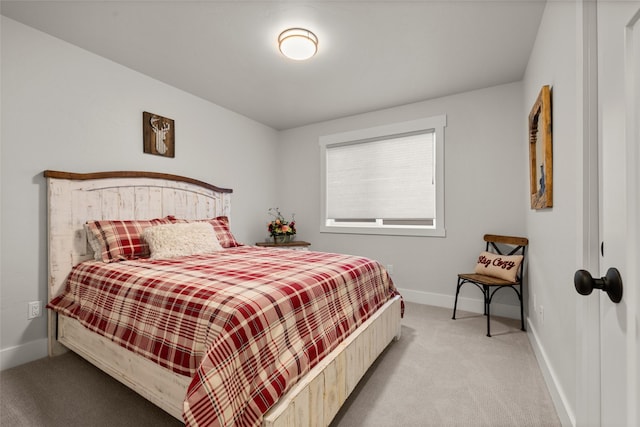 bedroom featuring baseboards and light colored carpet