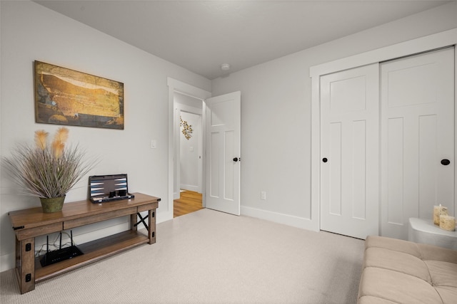 sitting room with carpet flooring and baseboards