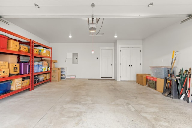 garage featuring electric panel and a garage door opener