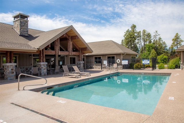 view of pool with a patio area and fence