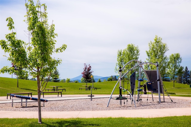 community jungle gym featuring a yard and a mountain view