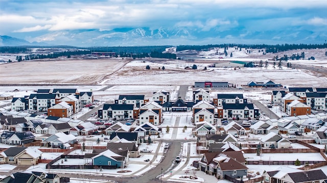 snowy aerial view with a residential view