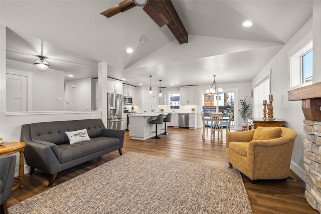 living area with vaulted ceiling with beams, ceiling fan with notable chandelier, dark wood finished floors, and recessed lighting