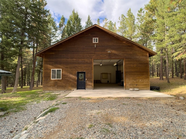 view of side of property with a detached garage