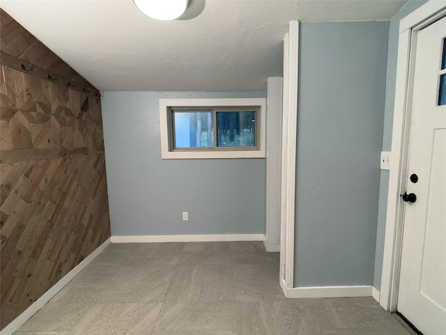 interior space with vaulted ceiling and baseboards