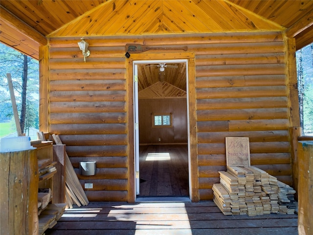 view of exterior entry featuring log siding