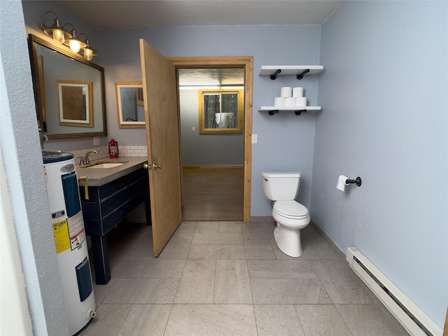 bathroom featuring baseboards, toilet, baseboard heating, vanity, and water heater