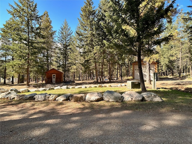 view of property's community featuring a garage and an outdoor structure