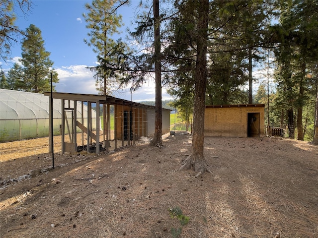 view of yard with an outdoor structure and exterior structure