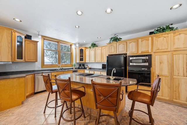 kitchen with a kitchen island with sink, black appliances, a breakfast bar area, and glass insert cabinets