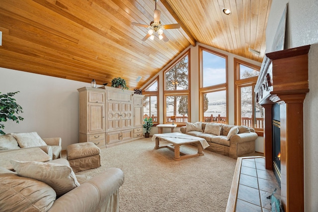 living area featuring light carpet, high vaulted ceiling, wooden ceiling, and a glass covered fireplace