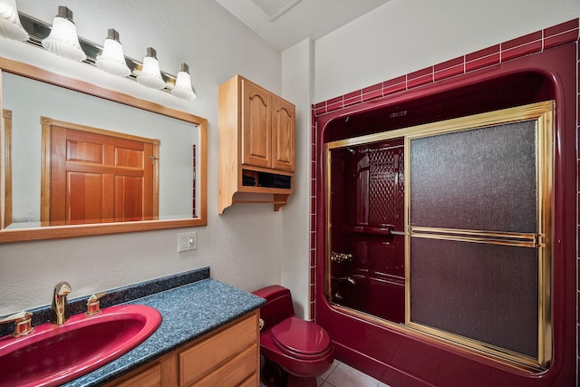 full bathroom featuring toilet, shower / bath combination with glass door, tile patterned floors, and vanity