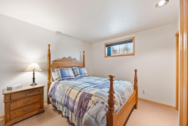 bedroom featuring light carpet and baseboards