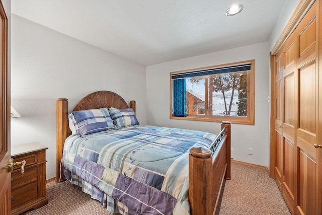 bedroom featuring light colored carpet and baseboards