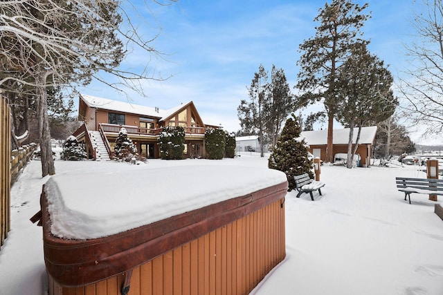 yard covered in snow with a deck and stairway