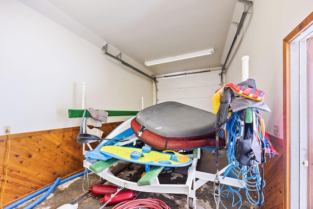 garage featuring wainscoting and wooden walls