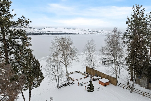 snowy aerial view with a water view