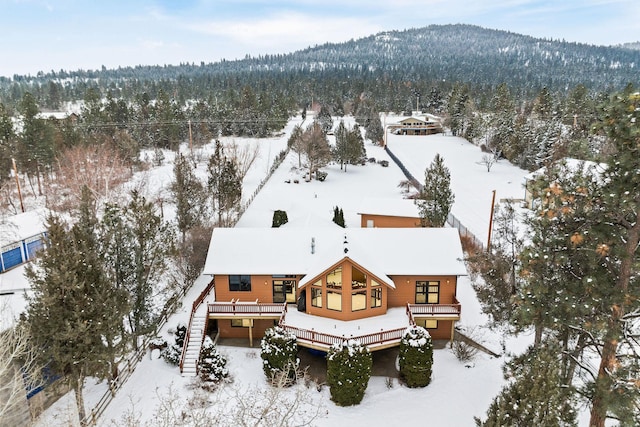 snowy aerial view with a view of trees