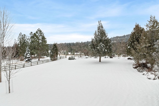 yard covered in snow with fence