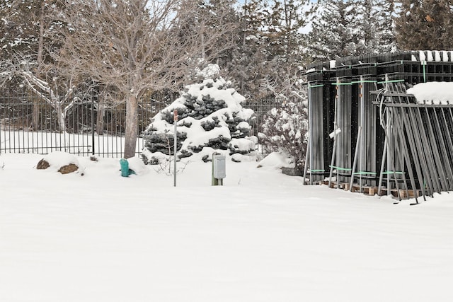 yard covered in snow with fence