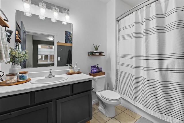 bathroom featuring toilet, curtained shower, tile patterned flooring, and vanity