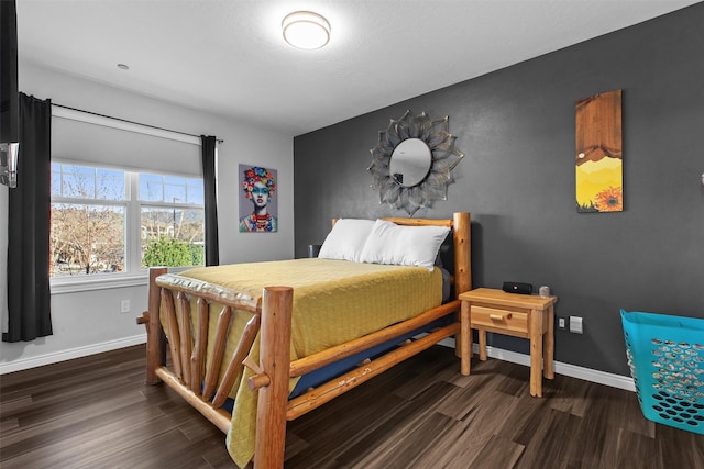 bedroom featuring dark wood-style flooring and baseboards