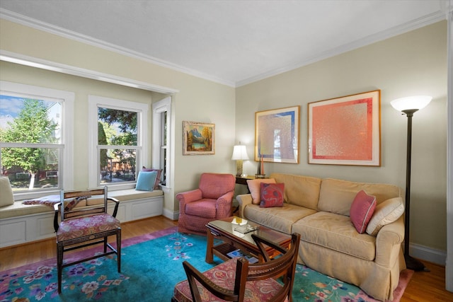 living room with ornamental molding, baseboards, and wood finished floors