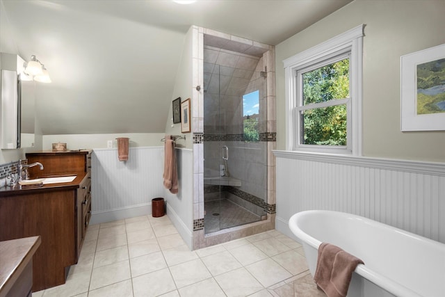 bathroom featuring a freestanding bath, wainscoting, a shower stall, vanity, and tile patterned floors