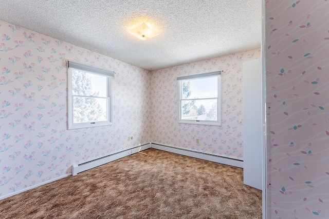 spare room with carpet, a textured ceiling, and wallpapered walls