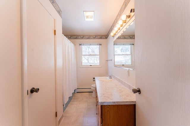 full bathroom with toilet, baseboard heating, and vanity