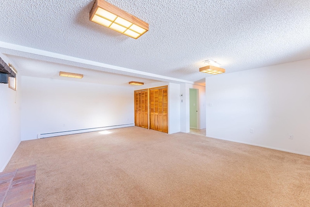 carpeted spare room with a baseboard radiator and a textured ceiling