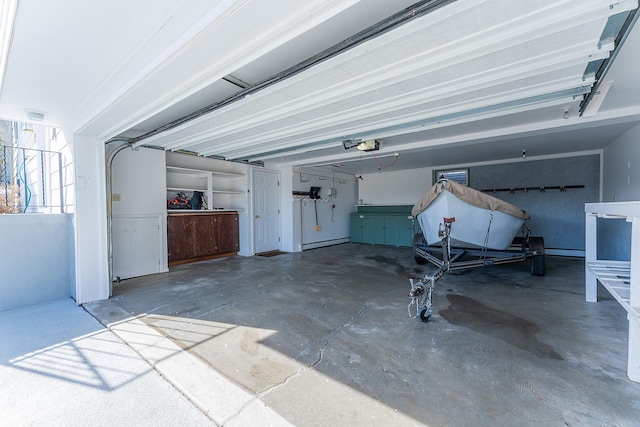 garage with a garage door opener and a baseboard radiator