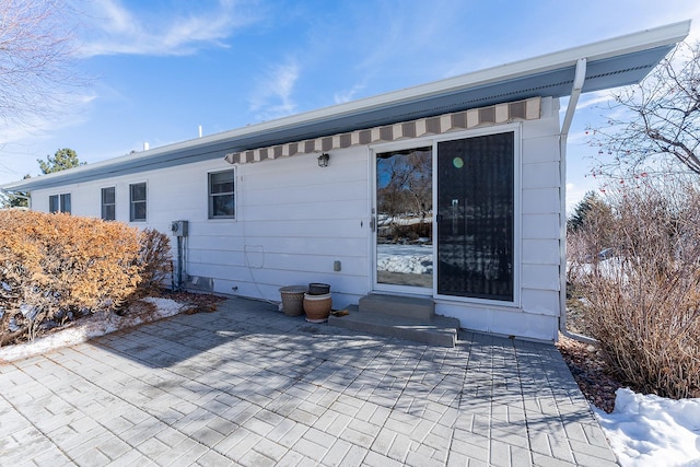 back of house featuring entry steps and a patio area